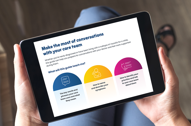 Two hands holding a tablet with doctor discussion guide on screen
