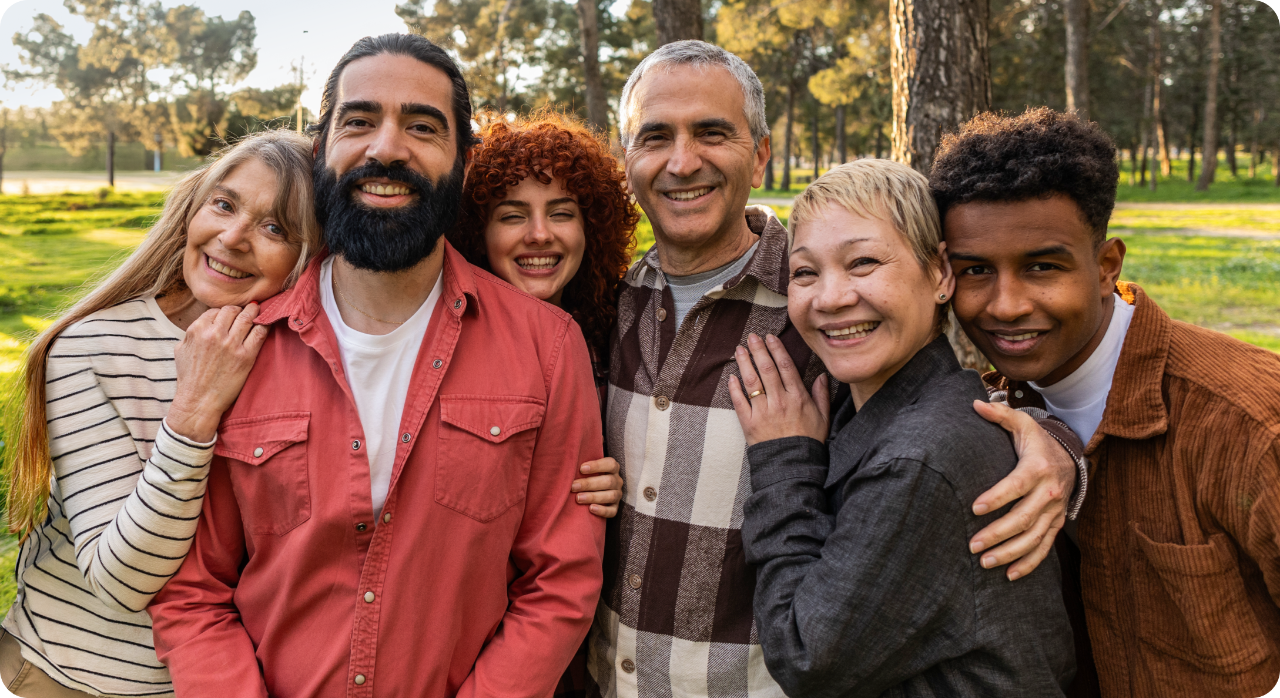 A group of 6 people hugging and posing for a photo